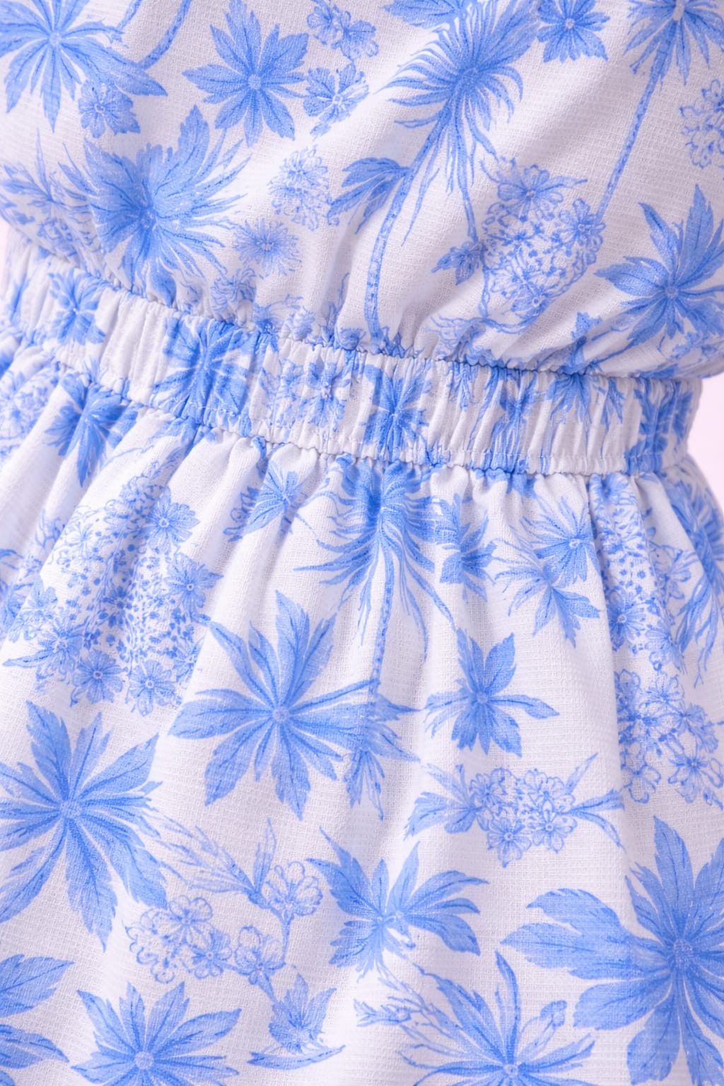 Close-up of blue white floral fabric on women’s midi dress