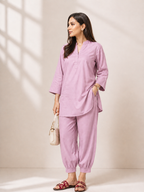 Woman wearing a lavender linen coord kurta set with tapered pants and relaxed fit styling.