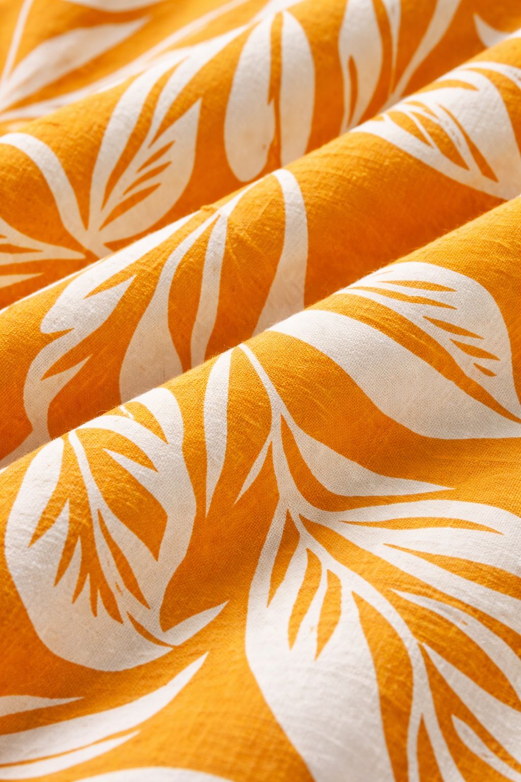 Close-up of fabric on orange culottes coord set for women