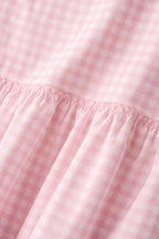 Close-up of pink gingham fabric on peplum coord set